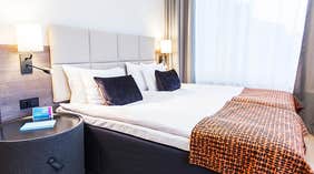 Standard dobbeltværelse med dobbeltseng med puder og tæppe hos Quality Hotel Winn Haninge